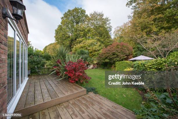 property exteriors gardens - garden decking stock-fotos und bilder