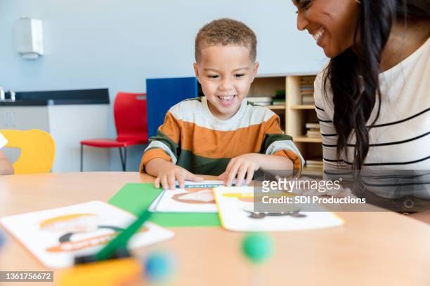 young boy imitates emotion flash cards - flash card stock pictures, royalty-free photos & images