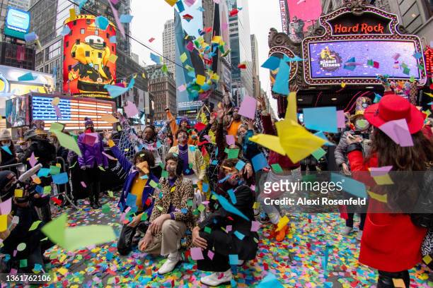 People watch and cheer as confetti is released from the Hard Rock Cafe marquee during a ‘confetti test’ ahead of New Year’s Eve in Times Square on...