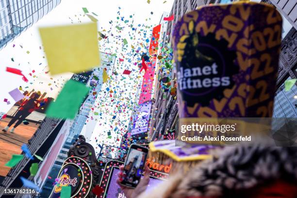 People watch and cheer as confetti is released from the Hard Rock Cafe marquee during a ‘confetti test’ ahead of New Year’s Eve in Times Square on...