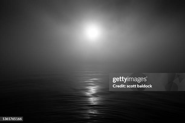 sun through the fog - moon horizon stock-fotos und bilder