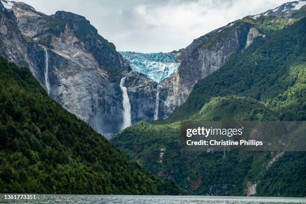 the dramatic view of the melting glacier in ventisquero colgante queulat national park, chile. - patagonia chile stock pictures, royalty-free photos & images