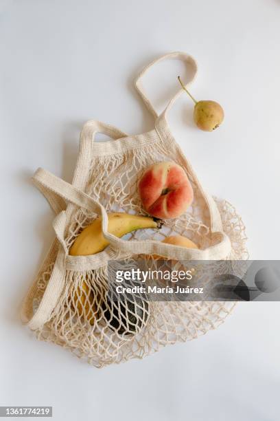 variety of fruits in eco bag on the table, white background - reusable bag isolated stock pictures, royalty-free photos & images