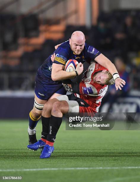 Matt Garvey of Worcester Warriors is tackled by Jack Bartlett of Gloucester Rugby during the Premiership Rugby Cup match between Worcester Warriors...
