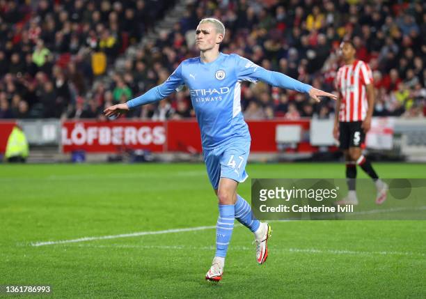 Phil Foden of Manchester City celebrates after scoring their sides first goal during the Premier League match between Brentford and Manchester City...
