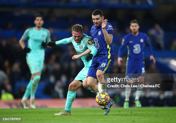 Mateo Kovacic of Chelsea is challenged by Alexis Mac Allister of Brighton & Hove Albion during the Premier League match between Chelsea and Brighton...