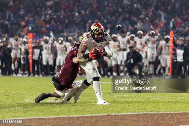 Greg Rose of the Maryland Terrapins returns a fumble recovery for a touchdown defended by Connor Blumrick of the Virginia Tech Hokies during the...