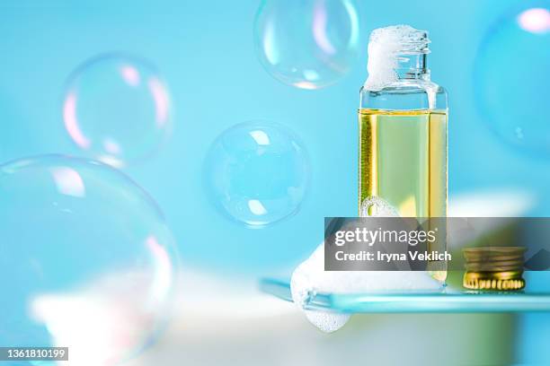 beauty product foam soap, shower gel or shampoo and  flying soap bubbles on trendy blue color  background. - shampoo bildbanksfoton och bilder