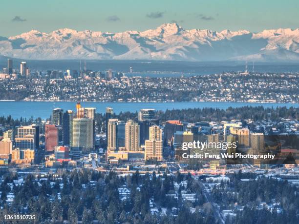 downtown bellevue with olympic mountains, lake washington, washington state, usa - bellevue washington state stock pictures, royalty-free photos & images