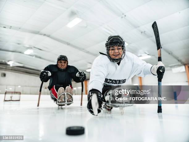 latin woman and her partner playing para hockey - athlete with disabilities stock pictures, royalty-free photos & images