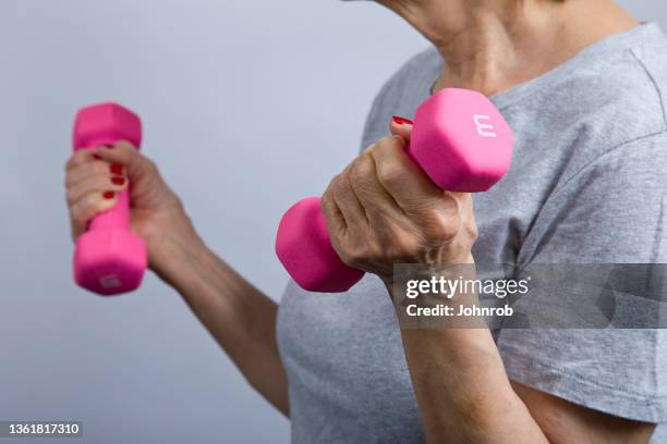 senior woman with dumbbells - hand weight stock pictures, royalty-free photos & images