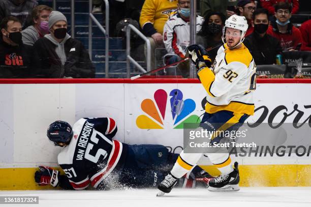 Ryan Johansen of the Nashville Predators hits Trevor van Riemsdyk of the Washington Capitals into the boards during the first period of the game at...