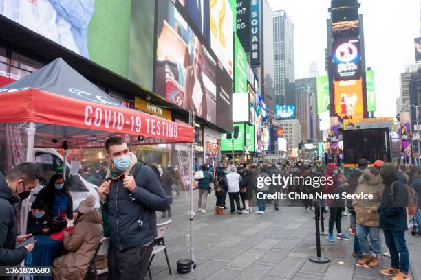 People queue up for COVID-19 nucleic acid testing at a testing facility in Times Square on December 29, 2021 in New York City.