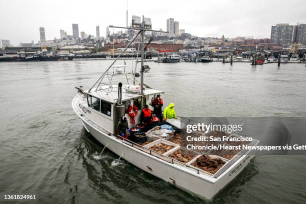 Carrying loads of Dungeness crab, a fishing boat called "Crown Royal" slows as it nears family-owned wholesale seafood company, Pezzolo Seafood, at...