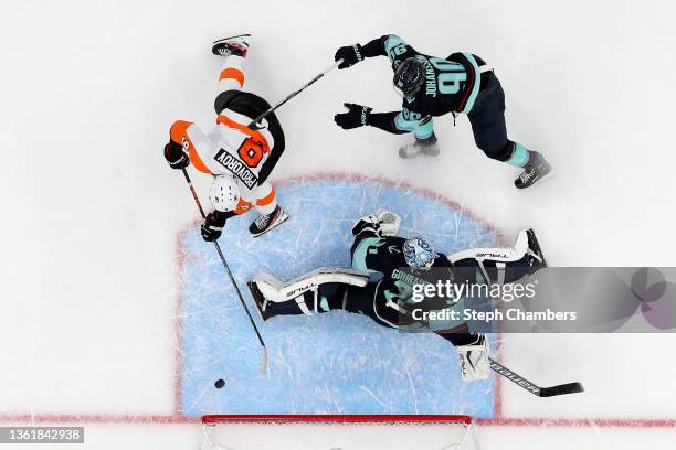 Ivan Provorov of the Philadelphia Flyers scores the game-winning goal in overtime against Philipp Grubauer of the Seattle Kraken at Climate Pledge...