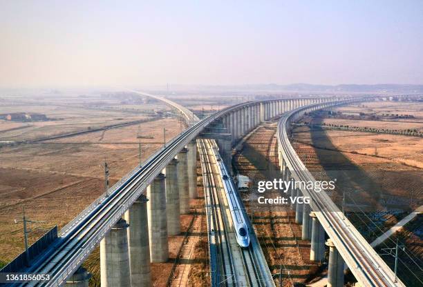 High-speed train travels on the Anqing-Jiujiang high-speed railway on December 30, 2021 in Jiujiang, Jiangxi Province of China. Linking Anqing in...