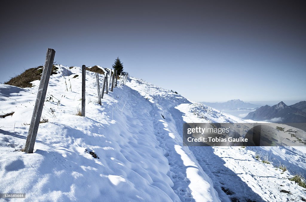 Fence on snowy landscape