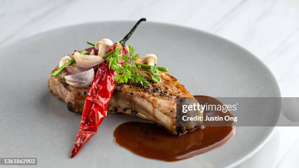 french styled porkchop with garnish on plate - french food stock pictures, royalty-free photos & images