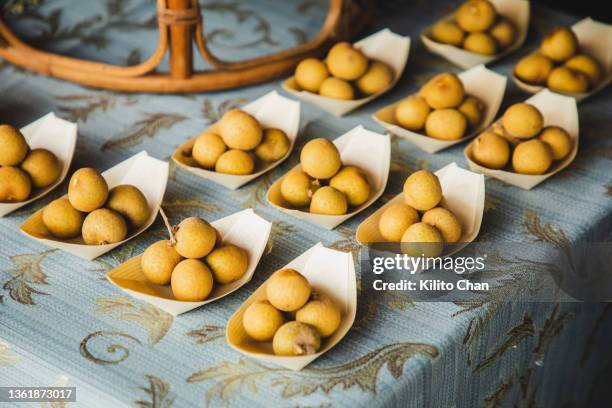 fresh longan on a basket - longan stock-fotos und bilder