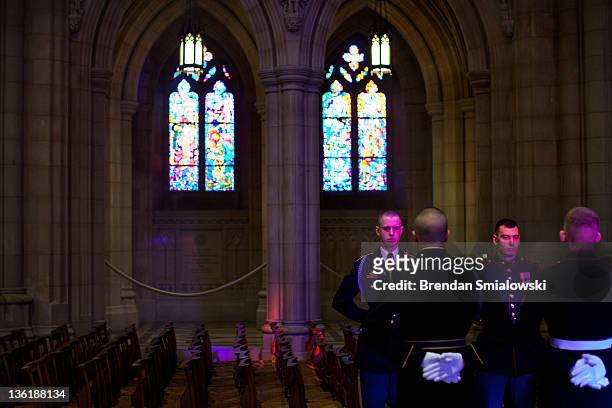 Members of a honor guard stand during a wreath laying at the National Cathedral December 28, 2011 in Washington, DC. A wreath was placed at the tomb...