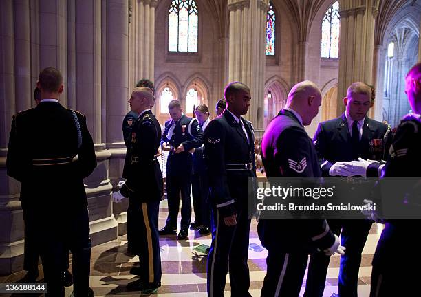 Members of a honor guard prepare for a wreath laying at the National Cathedral December 28, 2011 in Washington, DC. A wreath was placed at the tomb...