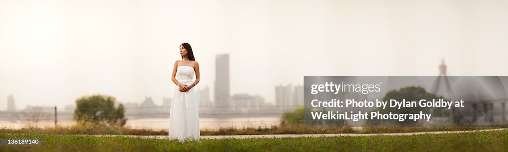 Young girl in wedding dress on road