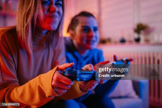 lesbian couple playing videogames together - manipulated stock pictures, royalty-free photos & images