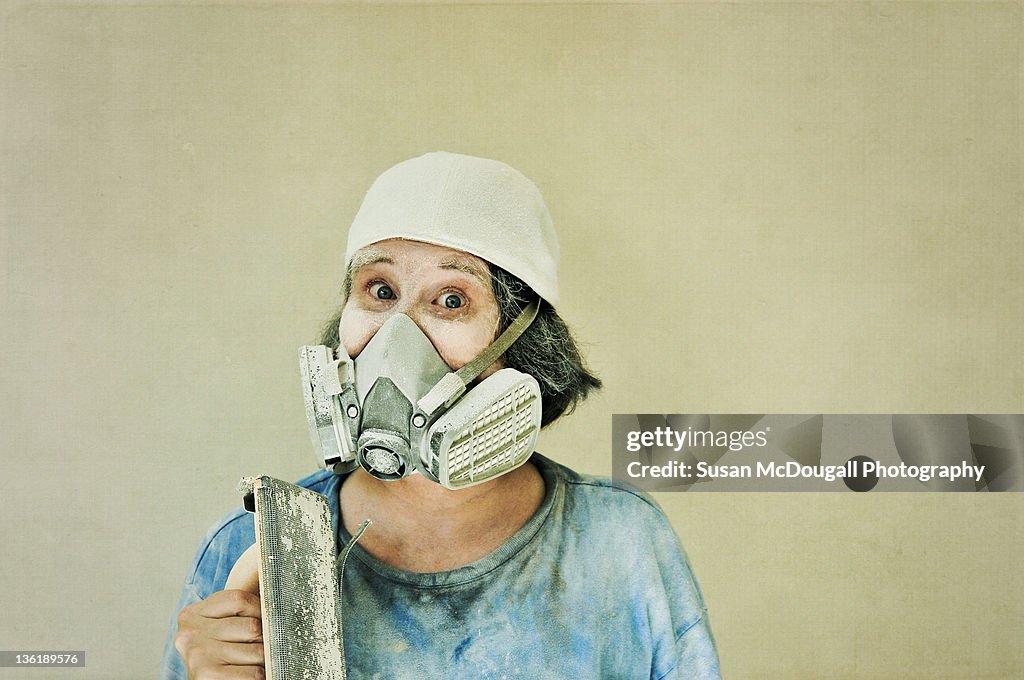 Woman with drywall sanding tool