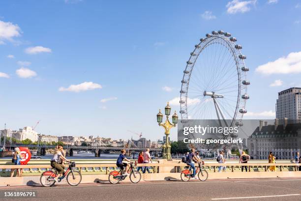 cyclists on westminster bridge in london - south bank london stock pictures, royalty-free photos & images