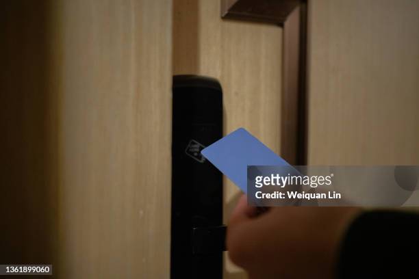 asians swipe card to enter hotel room - nyckelkort bildbanksfoton och bilder