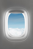 looking through a big jet passenger plane window,above the clouds
