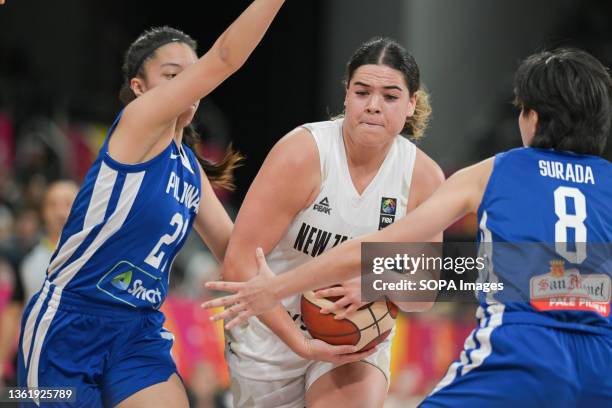 Camille Clarin of the Philippine Women Basketball team and Charlisse Leger-Walker of the New Zealand Women Basketball Team are seen in action during...