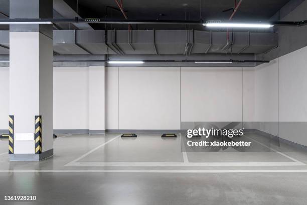 empty underground car park parking space - parking space imagens e fotografias de stock