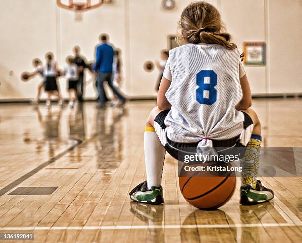 girl sitting on basketball - number 9 foto e immagini stock