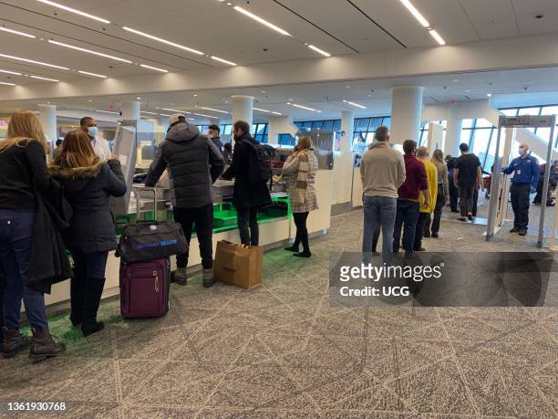 Crowds of travelers waiting for Security check, LaGuardia Airport, New York.