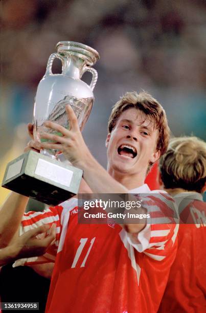 Denmark player Brian Laudrup holds aloft the trophy after their 2-0 victory against Germany in the 1992 UEFA Euro final played at the Nya Ullevi...