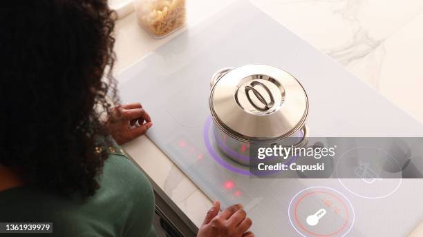 cooking pan on an induction cooktop seeing from above - smart kitchen stock pictures, royalty-free photos & images