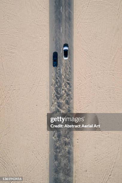 two cars racing on a desert road photographed from directly above, dubai, united arab emirates - auto racing photos 個照片及圖片檔