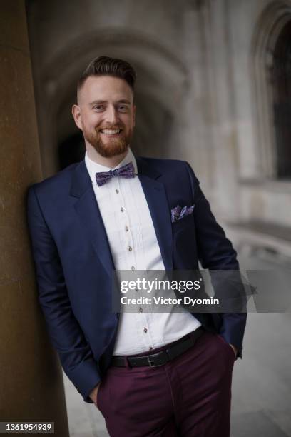 outdoor portrait of the bearded groom in the blue jacket - purple suit stock pictures, royalty-free photos & images