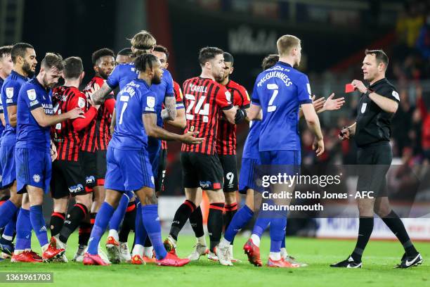 Referee James Linington shows a straight red to Leandro Bacuna of Cardiff City after a wild lunge on Philip Billing of Bournemouth during the Sky Bet...