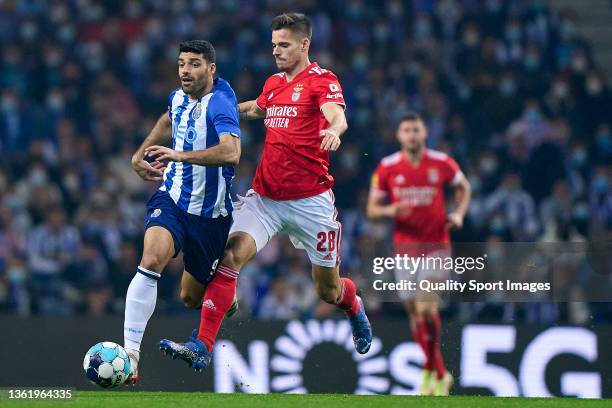 Julian Weigl of SL Benfica competes for the ball with Mehdi Taremi of FC Porto during the Liga Portugal Bwin match between FC Porto and SL Benfica at...
