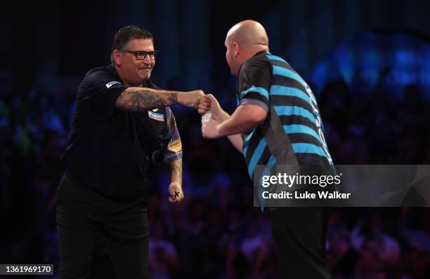 Gary Anderson of Scotland and Rob Cross of England congratulate each other after their Fourth Round Match during Day Thirteen of The William Hill...