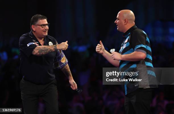 Gary Anderson of Scotland and Rob Cross of England congratulate each other after their Fourth Round Match during Day Thirteen of The William Hill...