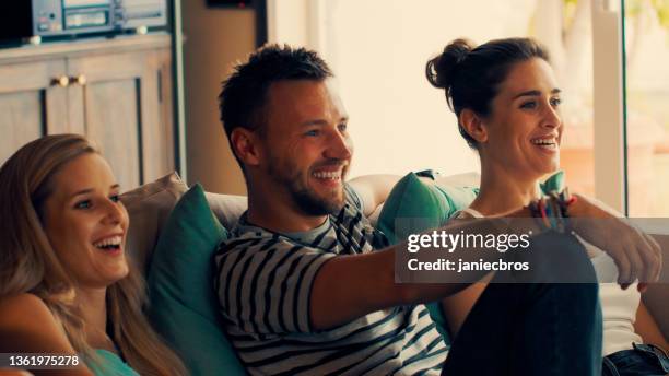 friends watching intense sports match. big emotions on a couch - drapeado stock pictures, royalty-free photos & images