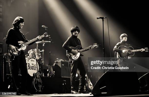 David Catlin-Birch, Andre Barreau and Adam Hastings of The Bootleg Beatles perform on stage at the Hammersmith Apollo on December 19, 2011 in London,...