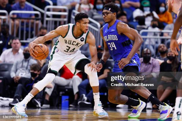 Giannis Antetokounmpo of the Milwaukee Bucks drives to the basket against Wendell Carter Jr. #34 of the Orlando Magic during the first half at Amway...