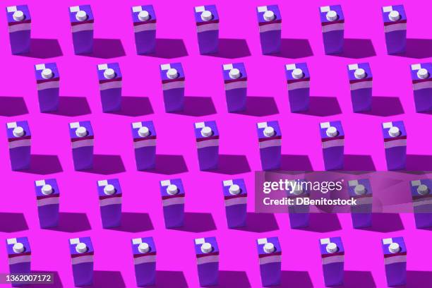 white, red and purple tetrabricks pattern with hard shadow on purple background. milk, water, recycling, food, supermarket and daily shopping price concept. - milk pack 個照片及圖片檔