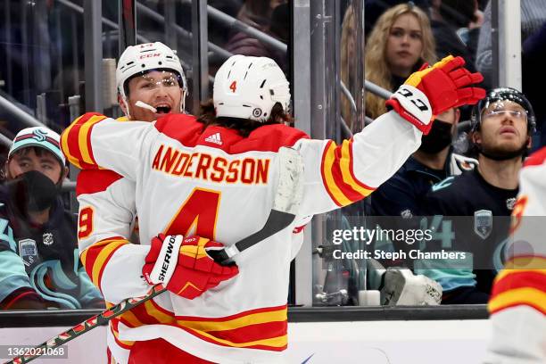 Matthew Tkachuk of the Calgary Flames celebrates his goal with Rasmus Andersson during the third period against the Seattle Kraken at Climate Pledge...