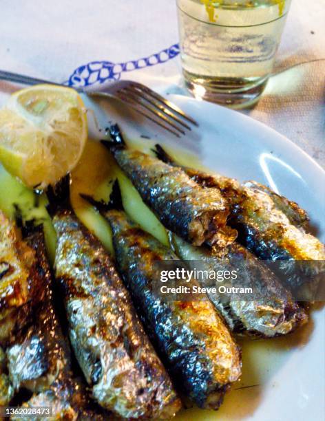 greek cuisine. grilled sardines, lesbos, greece - mytilini stockfoto's en -beelden