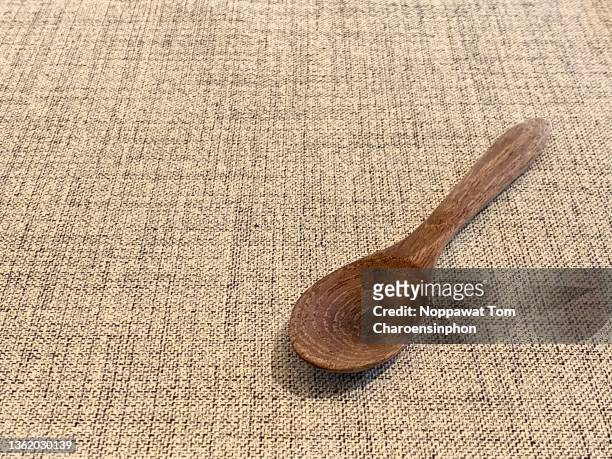 closed-up shot of wooden spoon on tablecloth, bangkok, thailand - utensile di portata foto e immagini stock